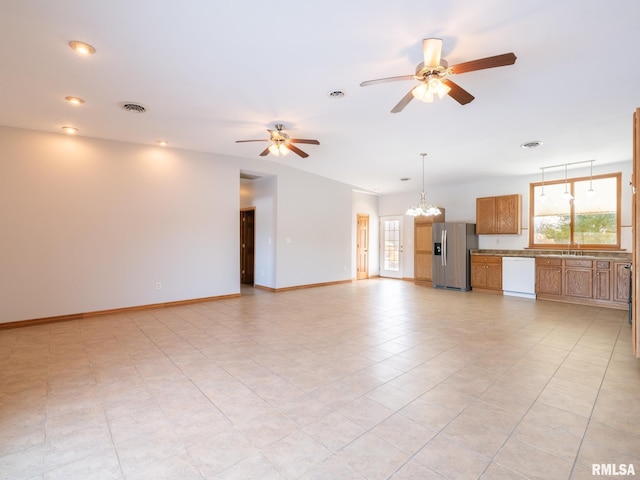 unfurnished living room featuring sink, light tile patterned flooring, and ceiling fan with notable chandelier