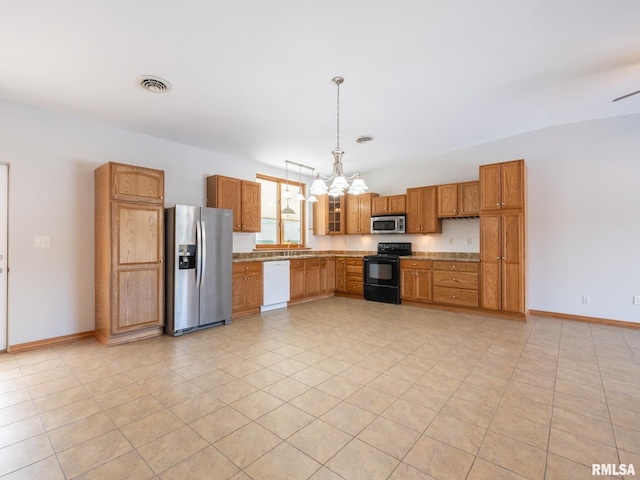 kitchen featuring light tile patterned flooring, an inviting chandelier, stainless steel appliances, and decorative light fixtures