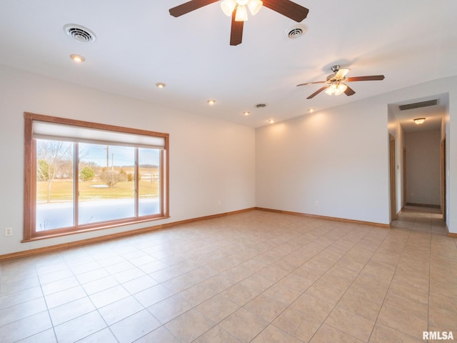 tiled spare room with ceiling fan