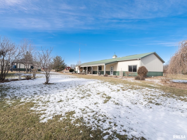 view of snow covered rear of property