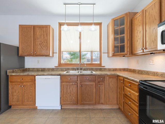 kitchen with hanging light fixtures, sink, and white appliances