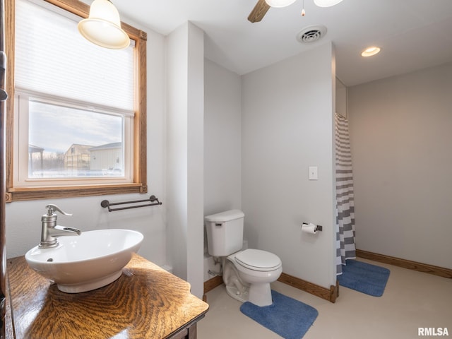 bathroom with toilet, ceiling fan, a shower with shower curtain, concrete flooring, and vanity