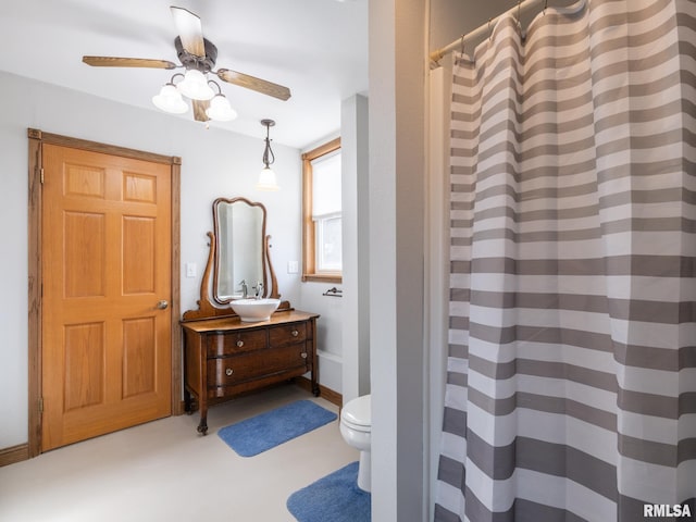 bathroom with ceiling fan, curtained shower, toilet, and vanity