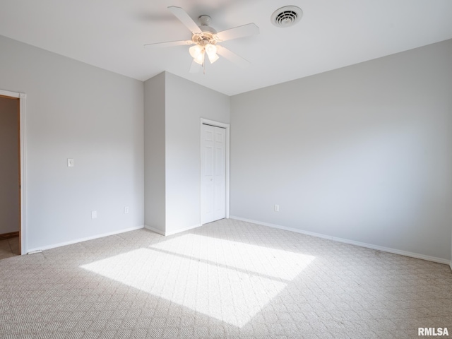 empty room featuring light carpet and ceiling fan