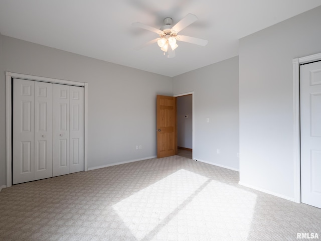 unfurnished bedroom with ceiling fan and light colored carpet