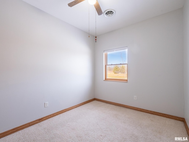 spare room with ceiling fan and carpet