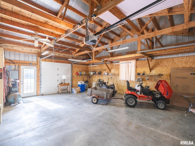 garage featuring a garage door opener and wooden walls