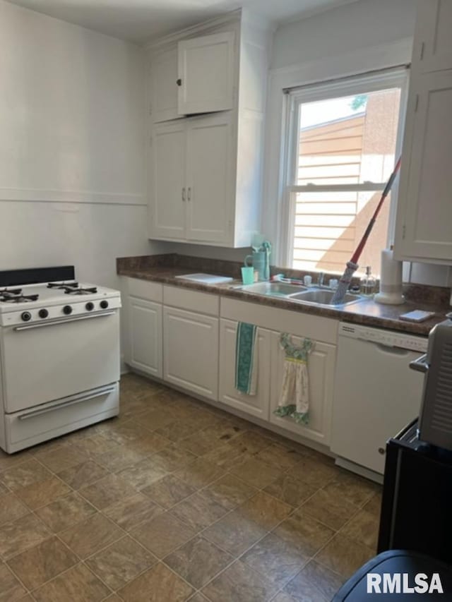 kitchen with white cabinetry, sink, and white appliances