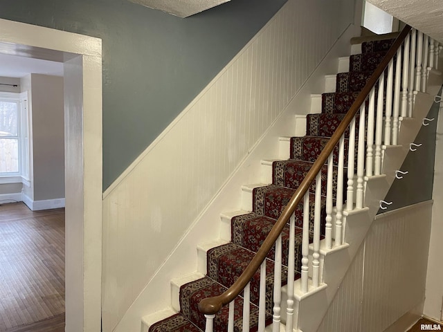 stairway featuring hardwood / wood-style flooring