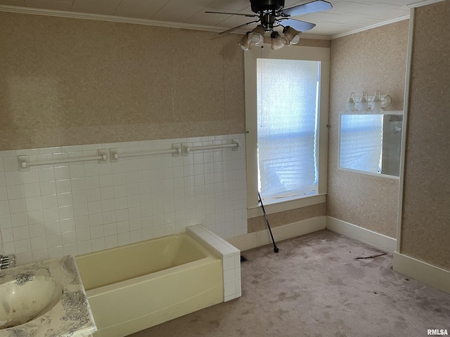 bathroom with ceiling fan, vanity, a bathtub, and crown molding