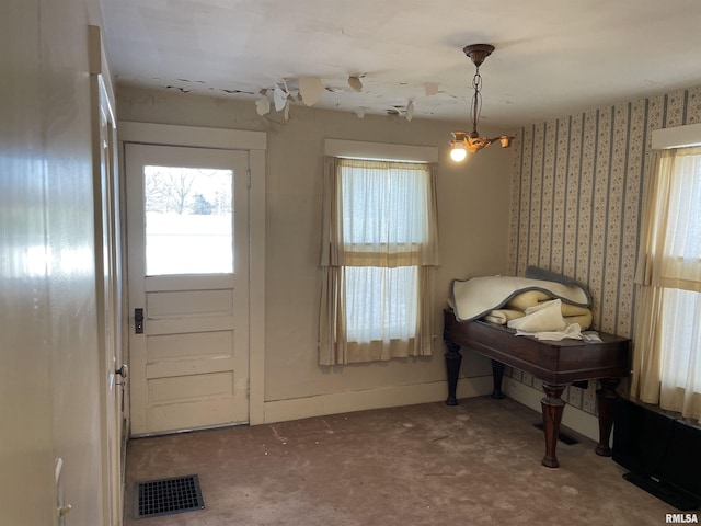 entrance foyer with carpet flooring