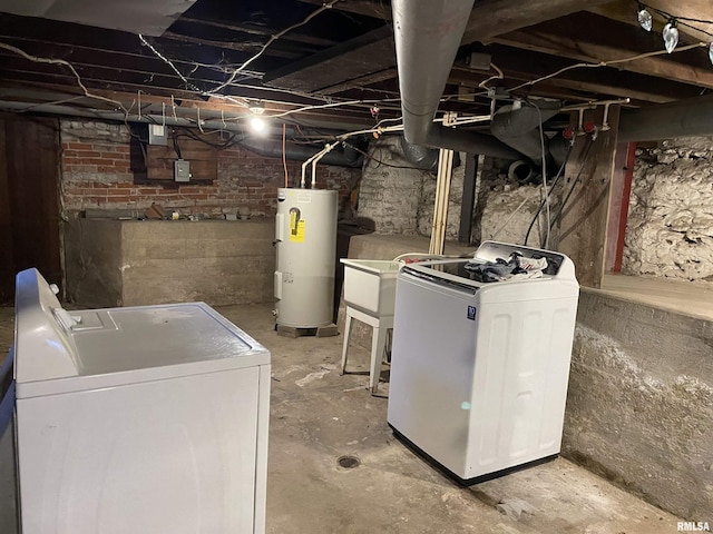 basement featuring independent washer and dryer and electric water heater