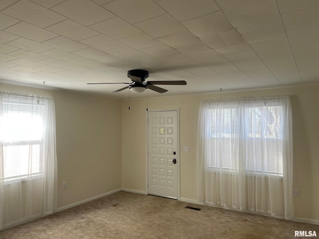 empty room with ceiling fan and light colored carpet