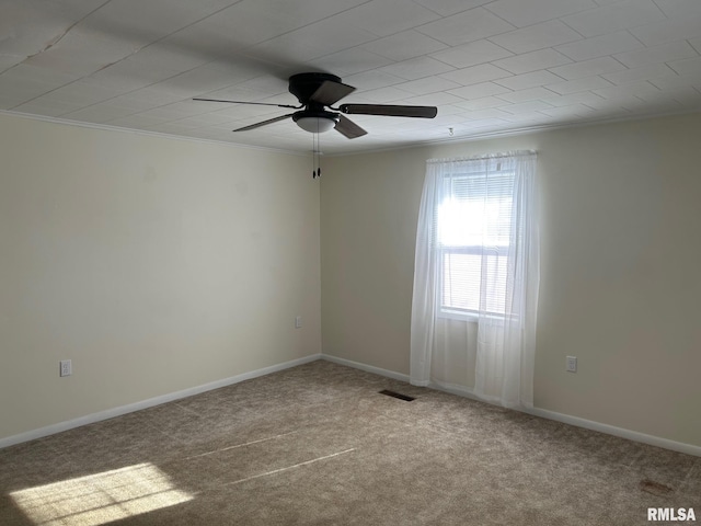 carpeted empty room with ceiling fan and ornamental molding