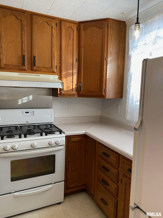 kitchen with pendant lighting and white appliances