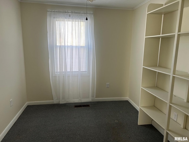 spare room featuring crown molding and carpet flooring