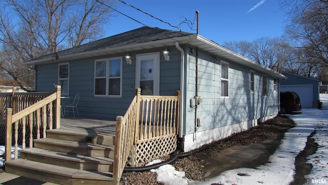 view of front of house with a garage and an outdoor structure