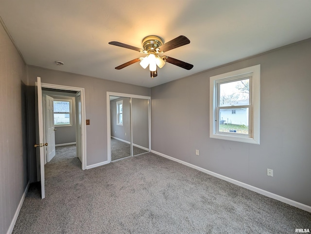 unfurnished bedroom featuring ceiling fan, a closet, and carpet floors