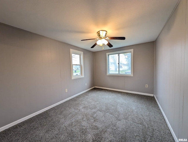 spare room featuring ceiling fan and carpet floors