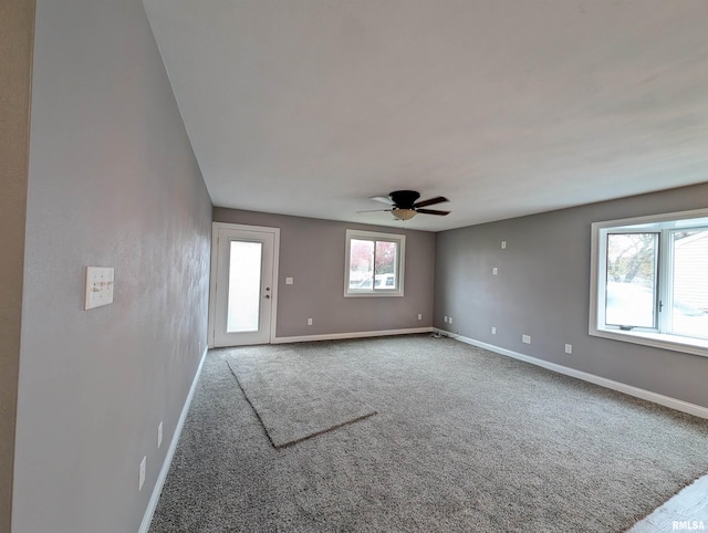 carpeted spare room with ceiling fan