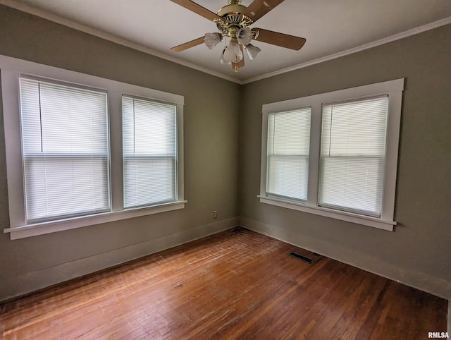 empty room featuring ceiling fan, ornamental molding, and hardwood / wood-style floors