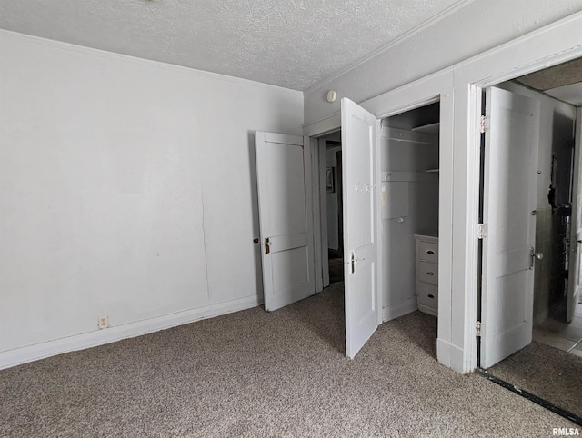 unfurnished bedroom with carpet floors, a textured ceiling, and a closet