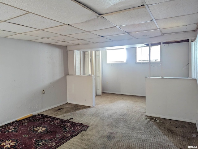 basement with carpet floors and a drop ceiling