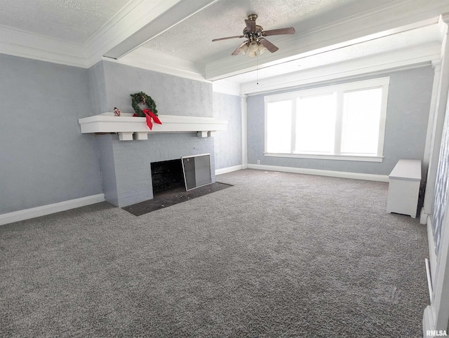 unfurnished living room with carpet, a textured ceiling, a fireplace, ceiling fan, and crown molding