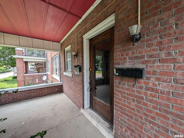 view of exterior entry with a porch