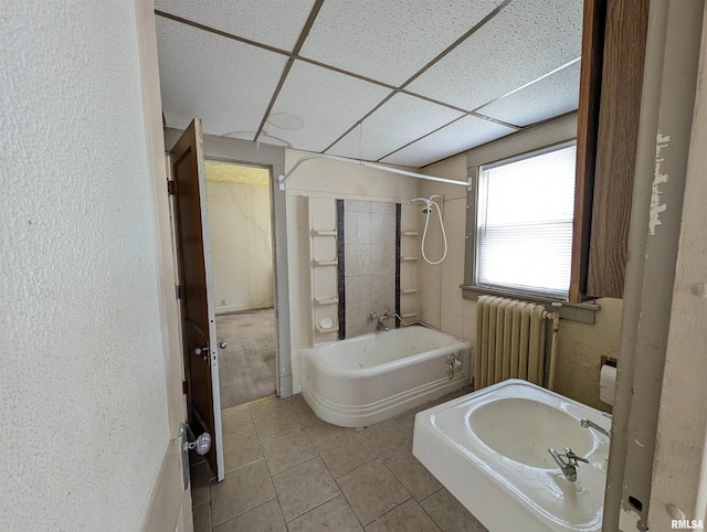 bathroom featuring radiator, a paneled ceiling, tile patterned floors, and tub / shower combination