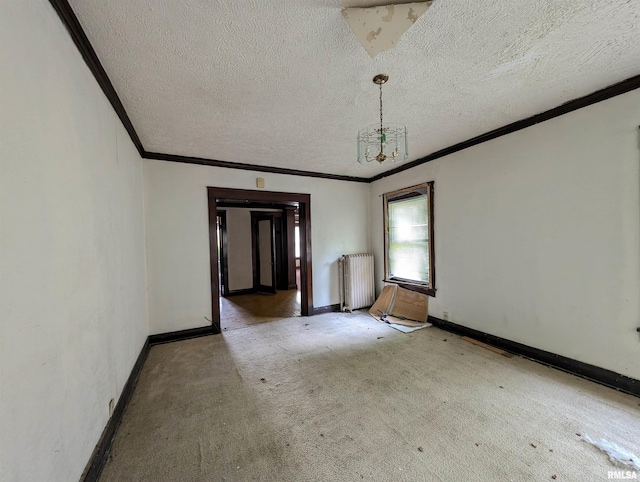 carpeted empty room with radiator, ornamental molding, a textured ceiling, and a notable chandelier