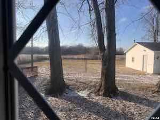 view of yard with a rural view and an outbuilding