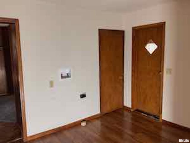 clothes washing area featuring dark hardwood / wood-style flooring