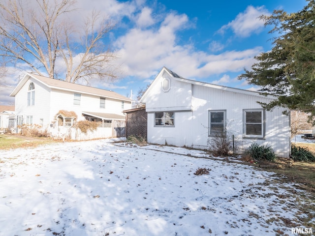 view of snow covered back of property