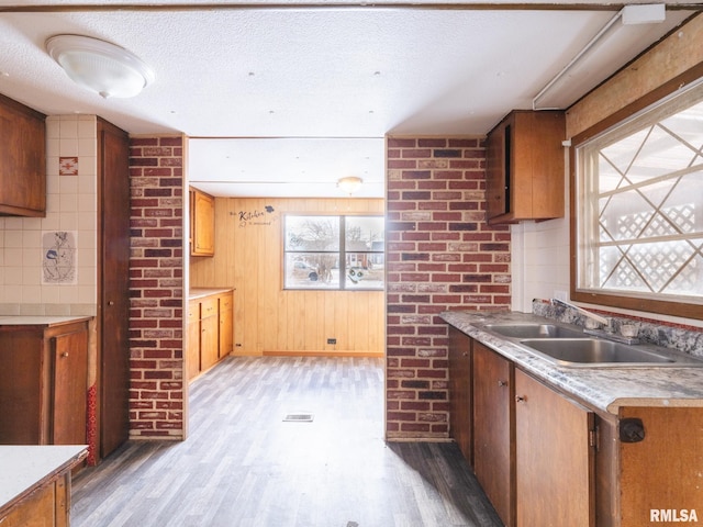 kitchen featuring sink, a textured ceiling, and hardwood / wood-style flooring