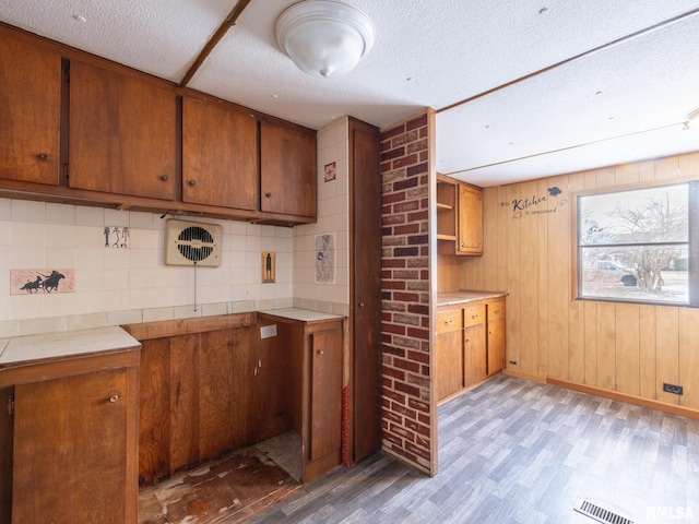 kitchen featuring light hardwood / wood-style floors and a textured ceiling