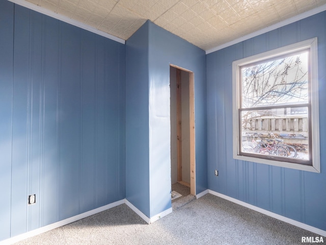 unfurnished bedroom with carpet and crown molding