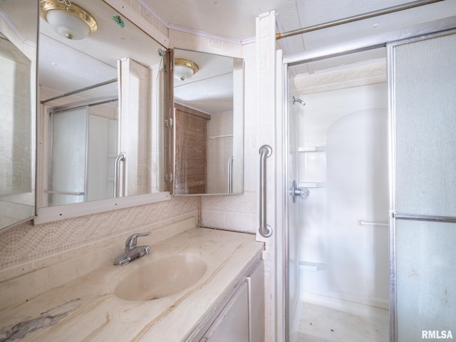 bathroom featuring decorative backsplash, a shower, and vanity