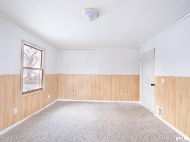 unfurnished room with crown molding and carpet flooring