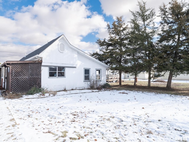 view of snow covered rear of property