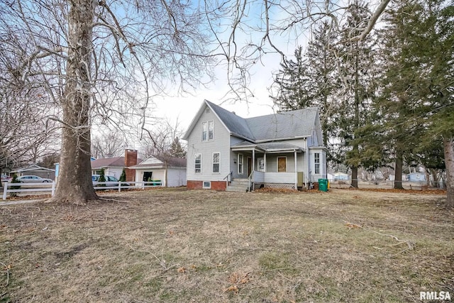 rear view of property with a yard