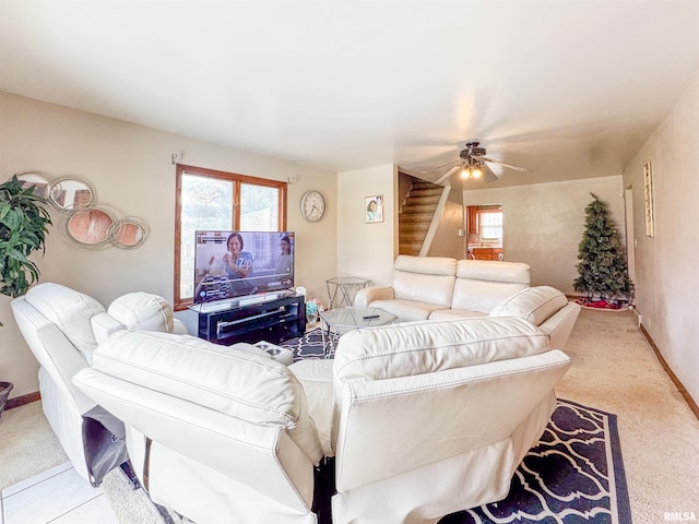 carpeted living room with ceiling fan