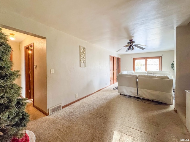 living room with light carpet and ceiling fan