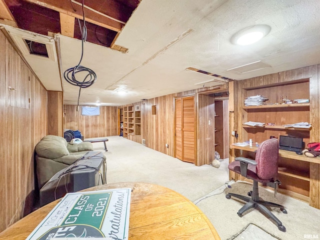 interior space with wooden walls and a textured ceiling