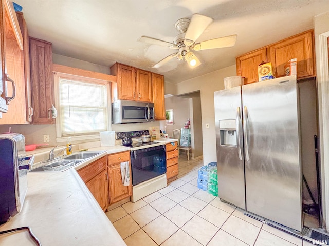 kitchen featuring light tile patterned flooring, ceiling fan, appliances with stainless steel finishes, and sink