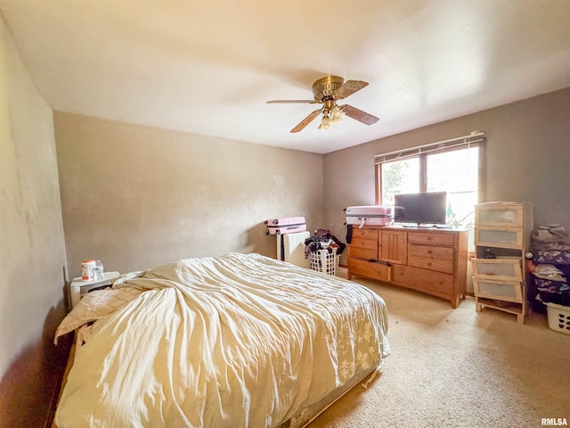 bedroom featuring ceiling fan and light carpet