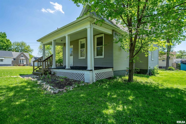 view of front of home with a front lawn and covered porch