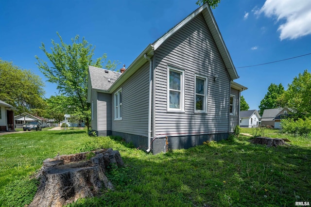 view of home's exterior with a lawn