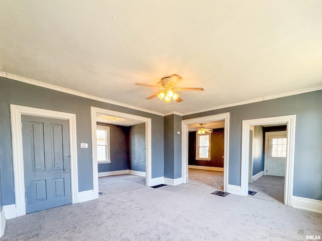 unfurnished bedroom with ceiling fan, light colored carpet, and multiple windows