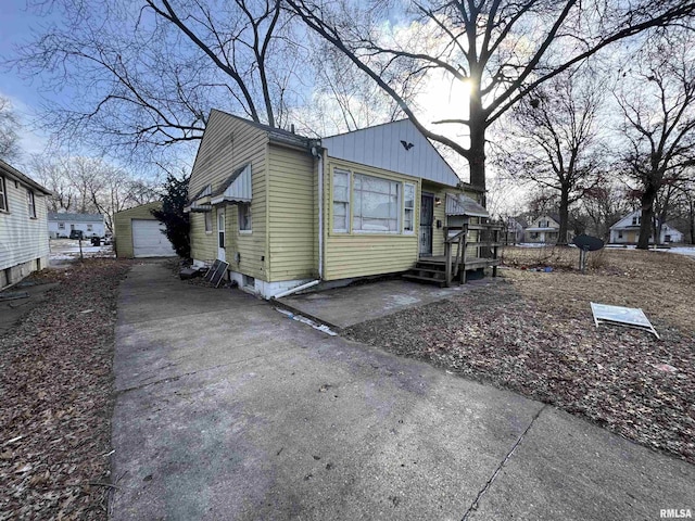 view of side of property with a garage and an outdoor structure